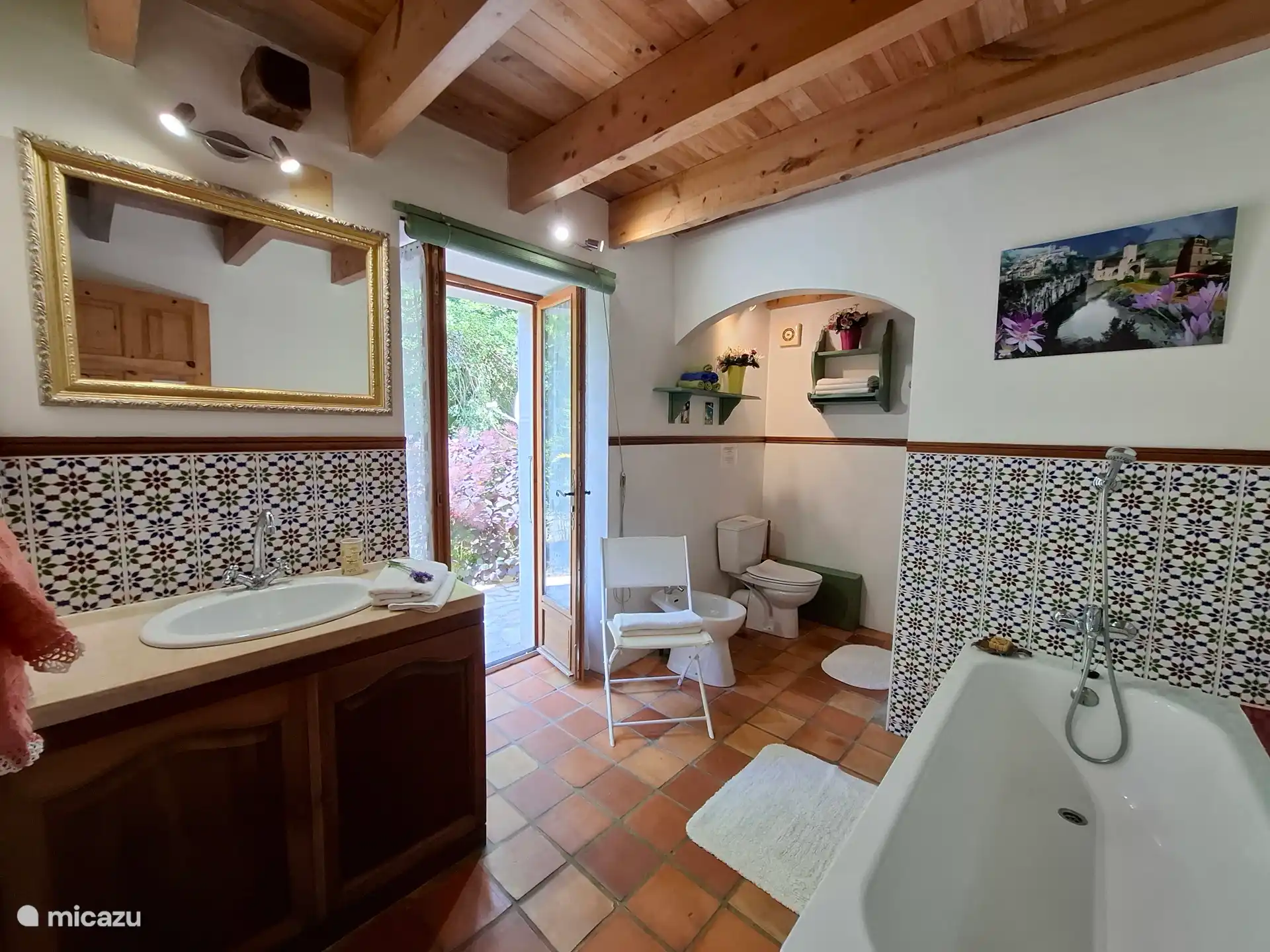 Large walk in shower behind the bath tub.