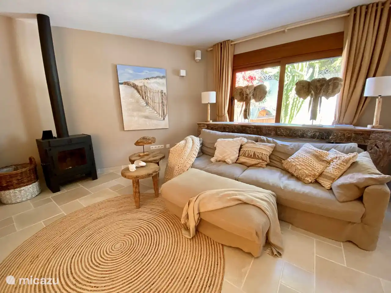 Comfortable sofa next to the wood-burning fireplace