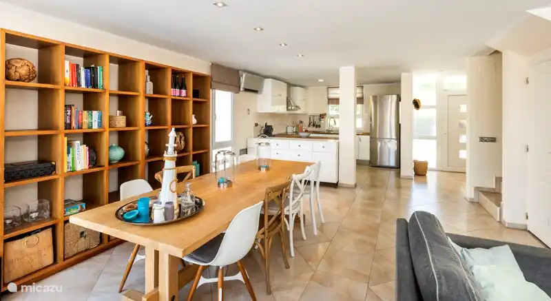 Cozy living room with large dining table with 8 chairs.