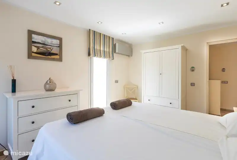 Cozy spacious bedroom with chest of drawers and wardrobe. Double beds that can also be pushed apart if desired.