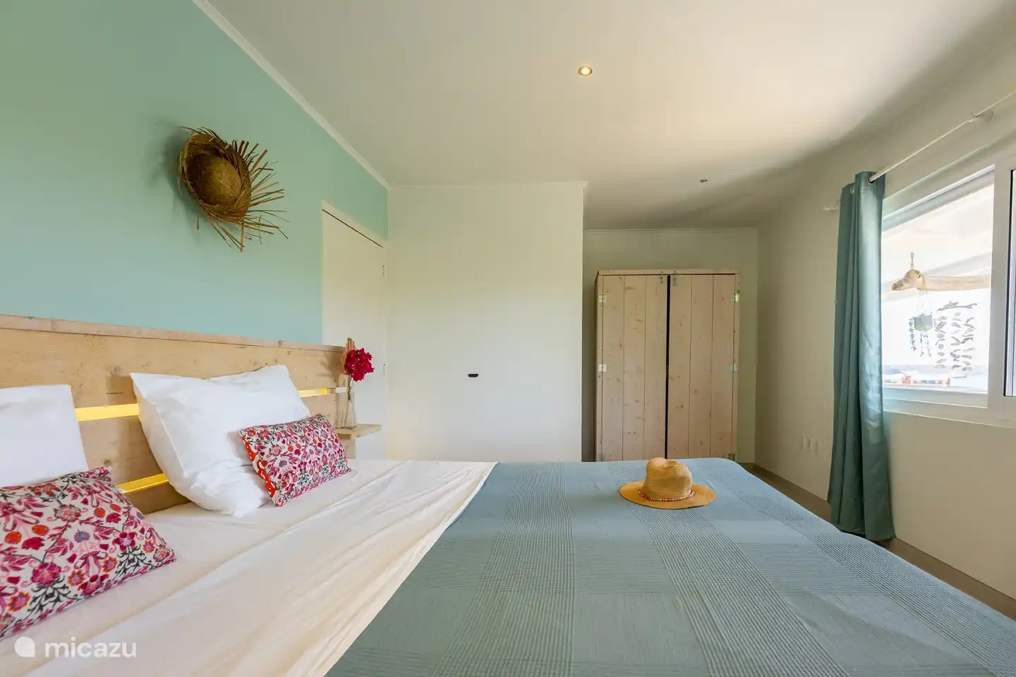Upper floor: Bedroom 1 with a view of the porch/verandah and the Caribbean Sea.