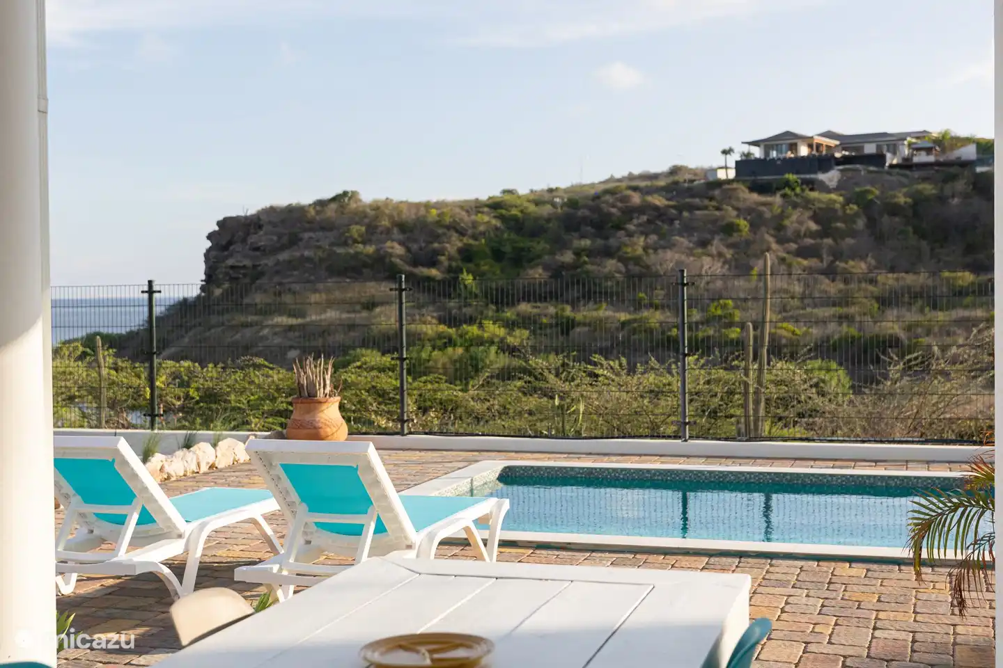 Ground floor: Relax by the pool with a sea view.