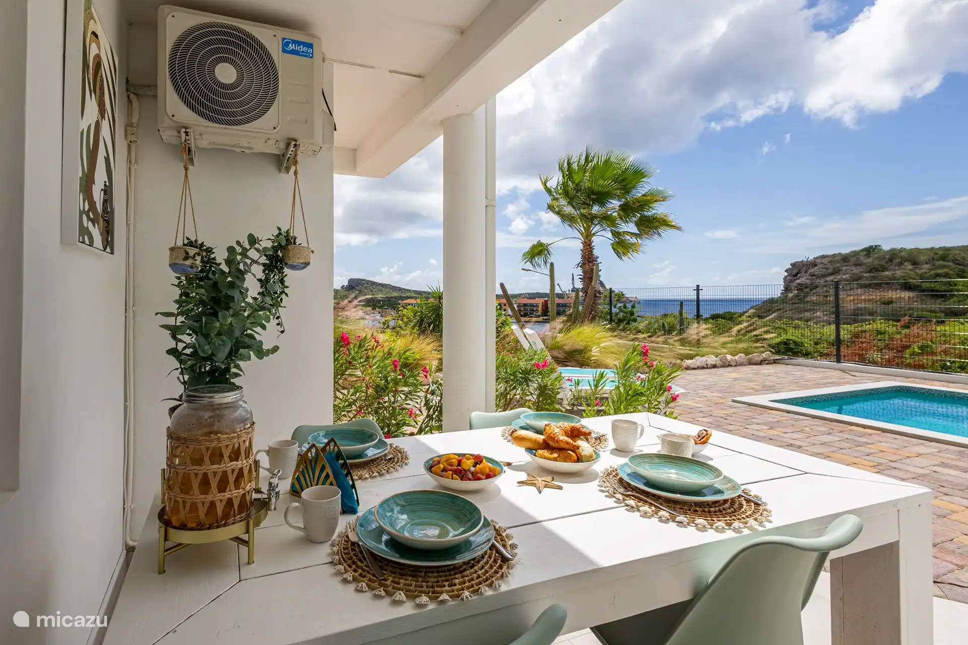 Breakfast lower floor by the pool with sea view.