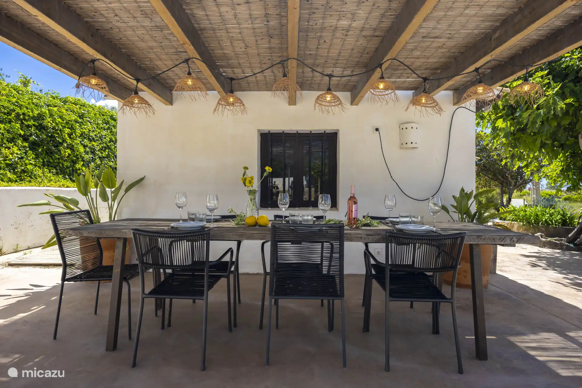 There is a beautiful terrace with a large dining table.