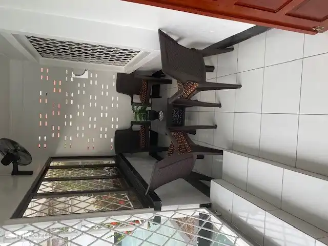 balcony with chairs and fan. in 2024