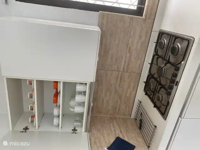 sufficient kitchen utensils in hanging cupboards