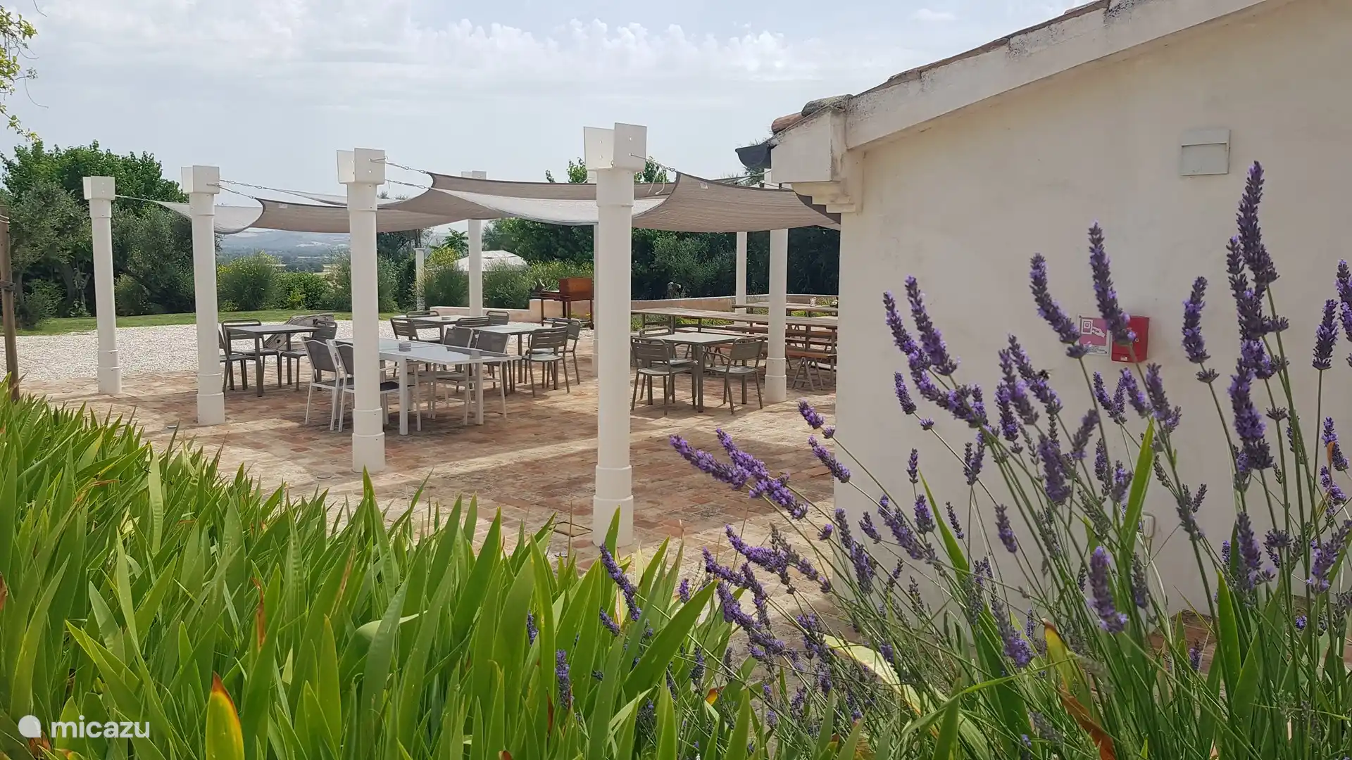Pergola with sufficient shade, long tables, toilets, changing room and communal laundry room