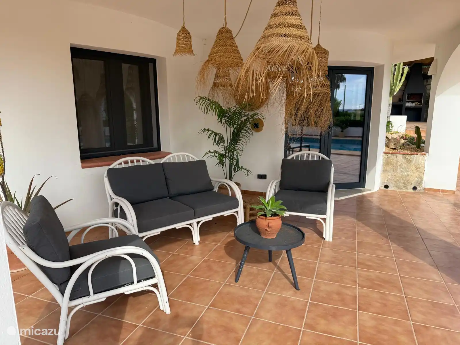 the covered terrace in front of the apartment