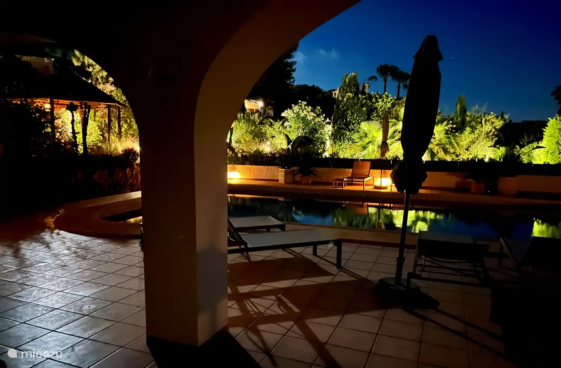 The garden is beautifully lit at night