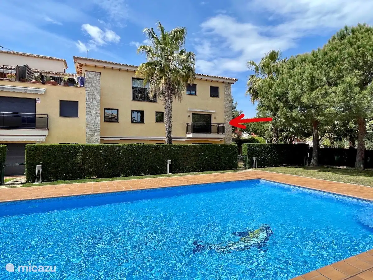 apartment on the first floor overlooking the courtyard with swimming pools and palm trees