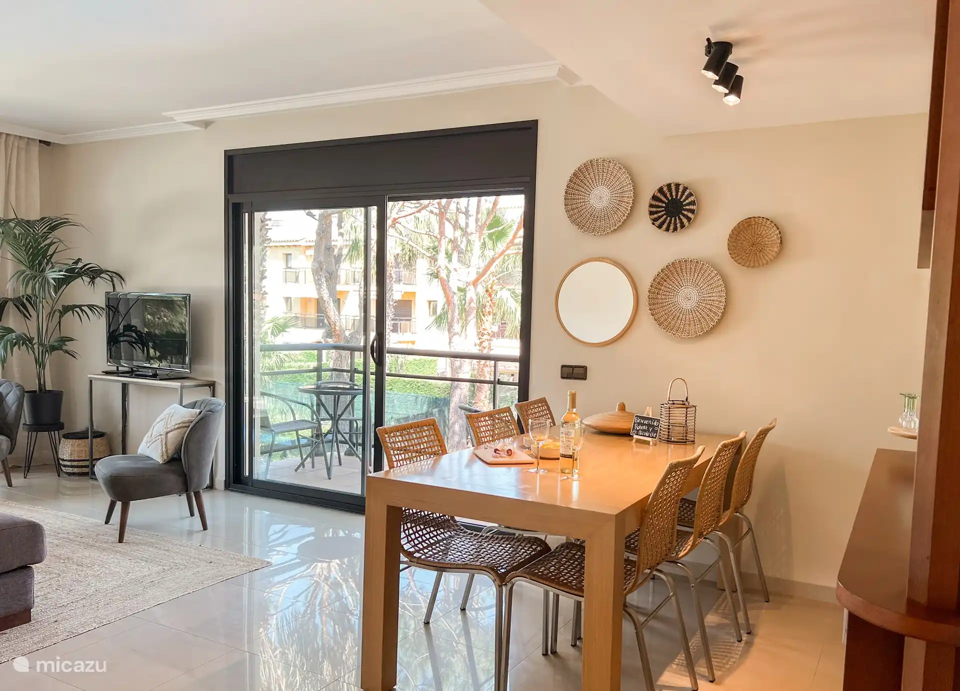 Large sliding doors with terrace and 6 chairs and 2 bistro tables.