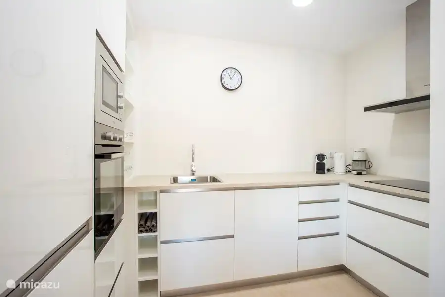 New open kitchen with induction hob, oven, microwave, fridge-freezer, kettle, toaster and Nespresso machine. Furthermore, plenty of crockery, cutlery and kitchen utensils.