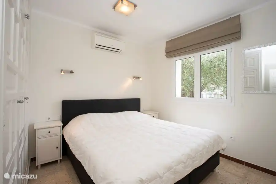 One of the spacious bedrooms with spacious closet and air conditioning.