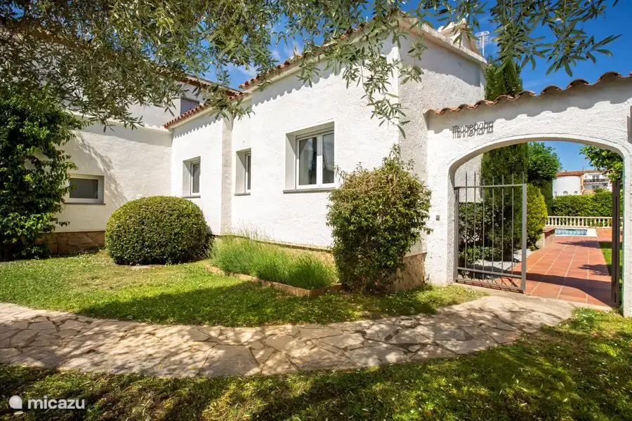 The front garden of the villa with a gate to the backyard for extra security and privacy.