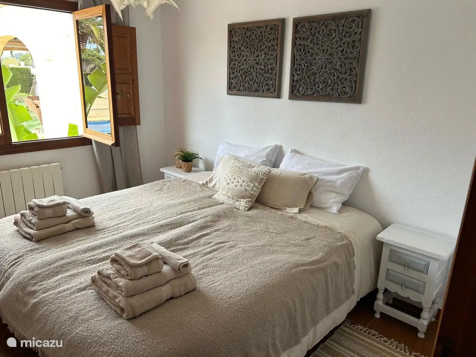 Bedroom 2 has French windows and views of the garden and pool. The box spring beds can be made up and taken apart as a single person. 