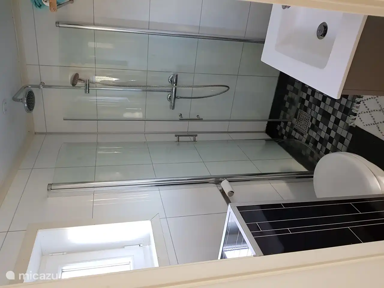 Bathroom with shower, toilet and sink. The bathroom has underfloor heating.