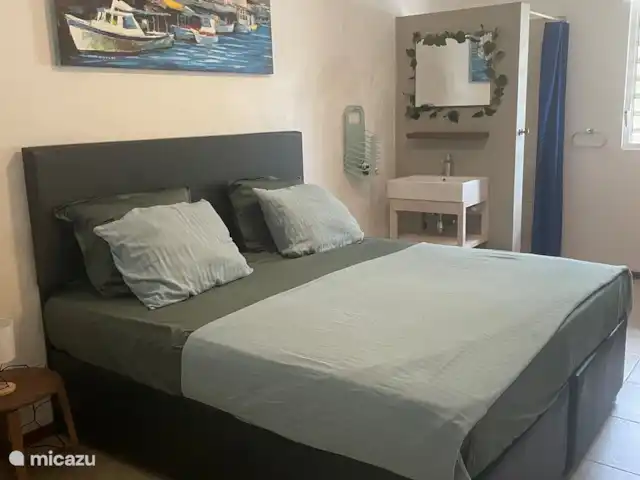 appartement huren in Curaçao, Banda Ariba (oost), Cas Grandi – Dushi Cocobana De master bedroom is voorzien van een kingsize bed met een eigen douche en wastafel