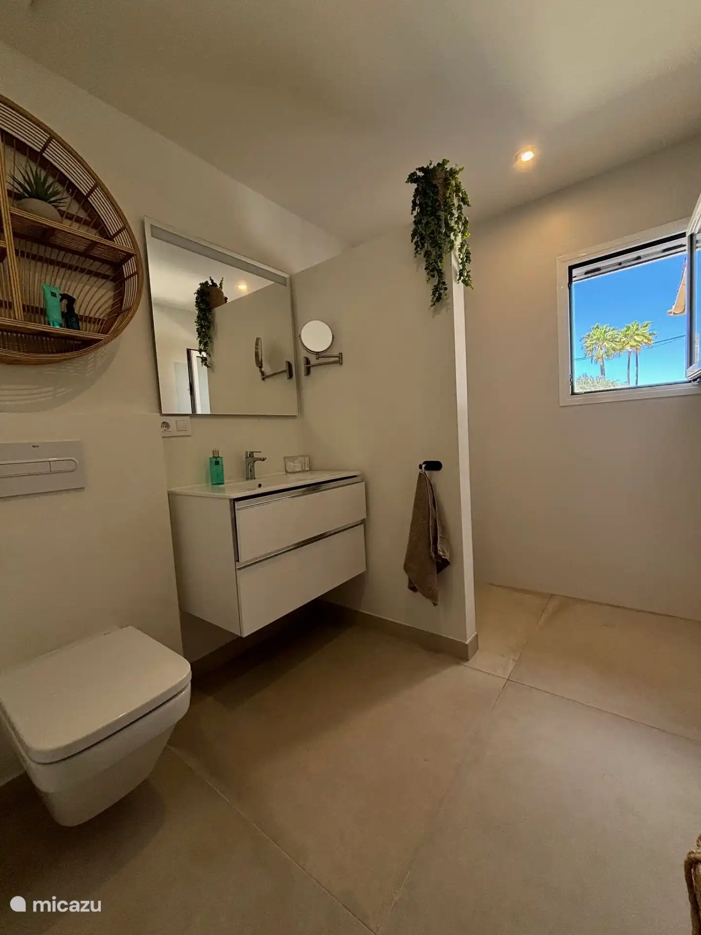 The bathroom in the master bedroom has a toilet, sink and a walk-in shower.