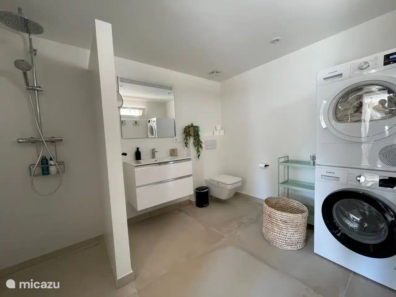 The washing machine and dryer are located in one of the downstairs bathrooms
