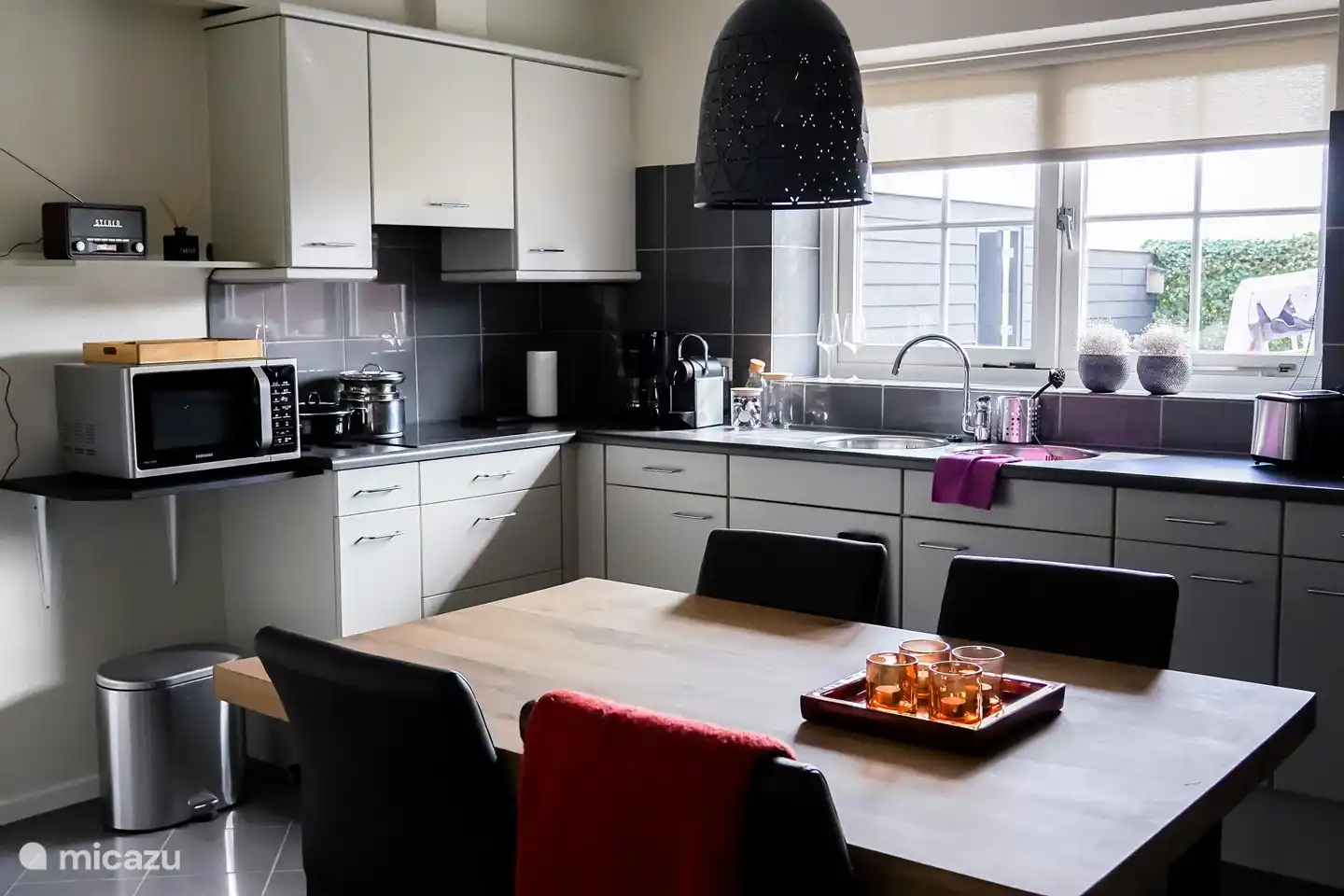 Cuisine avec accessoires et vue sur la prairie.