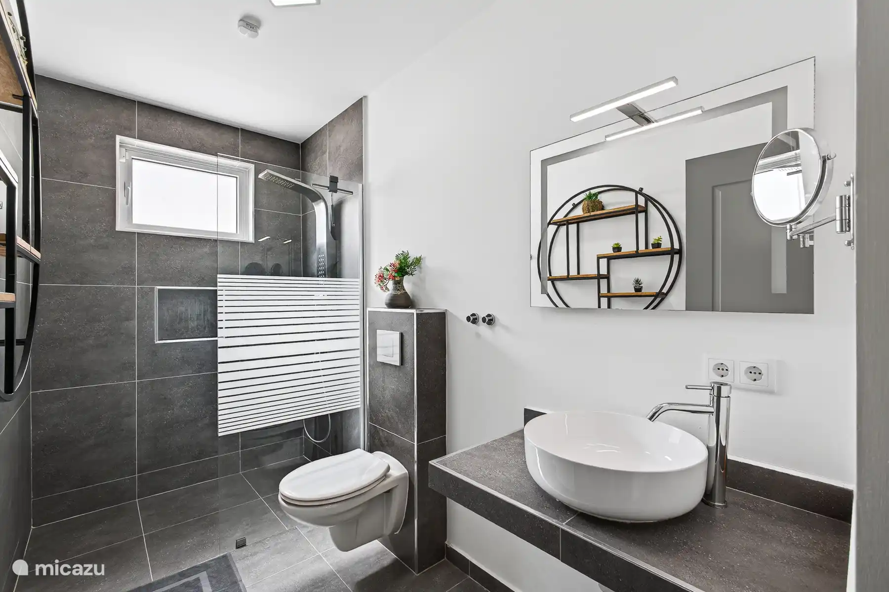 Moderne badkamer met wastafel, toilet en inloopdouche.