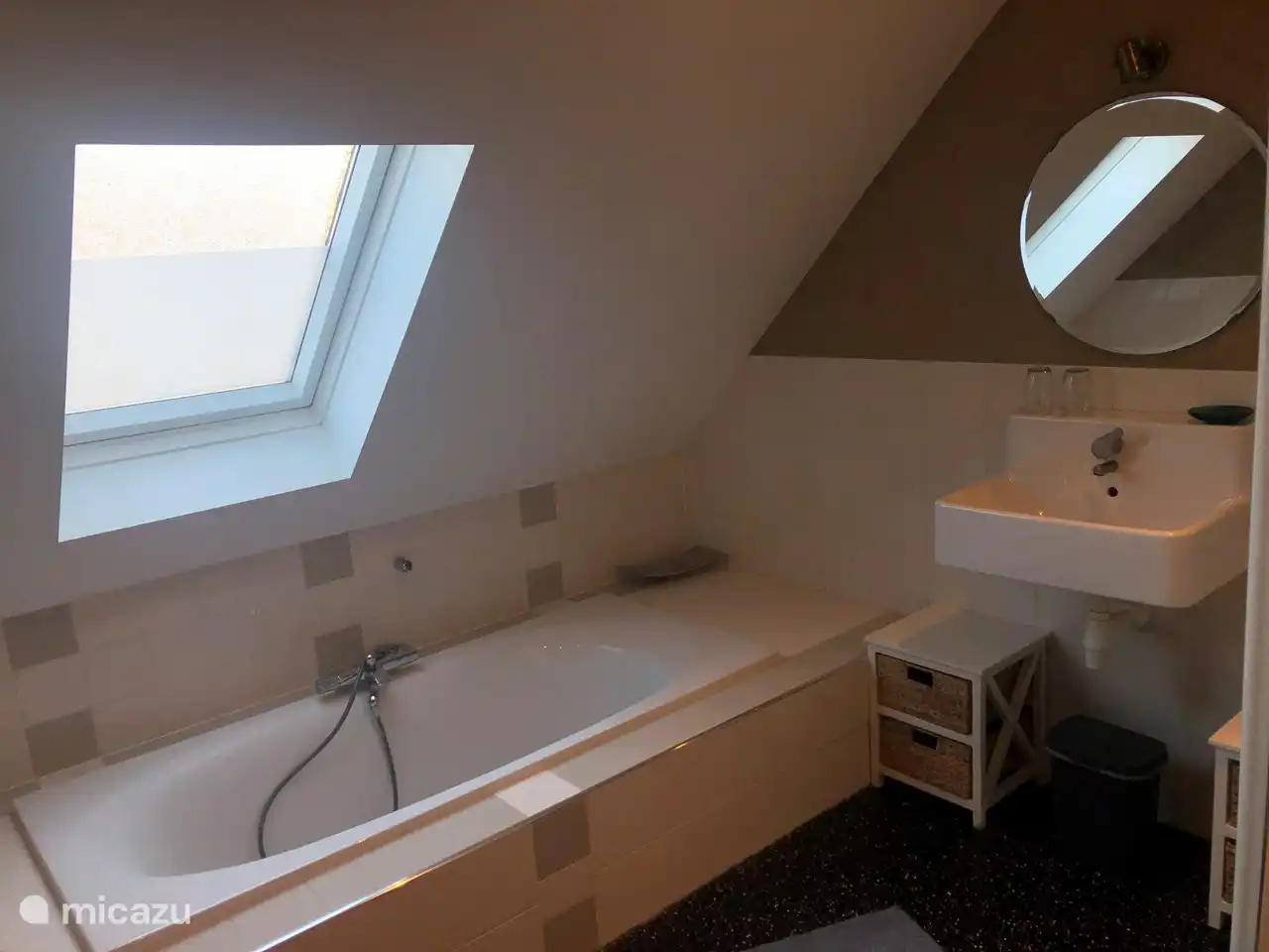 The bathroom overlooking a log bath with lowered entry and sink.