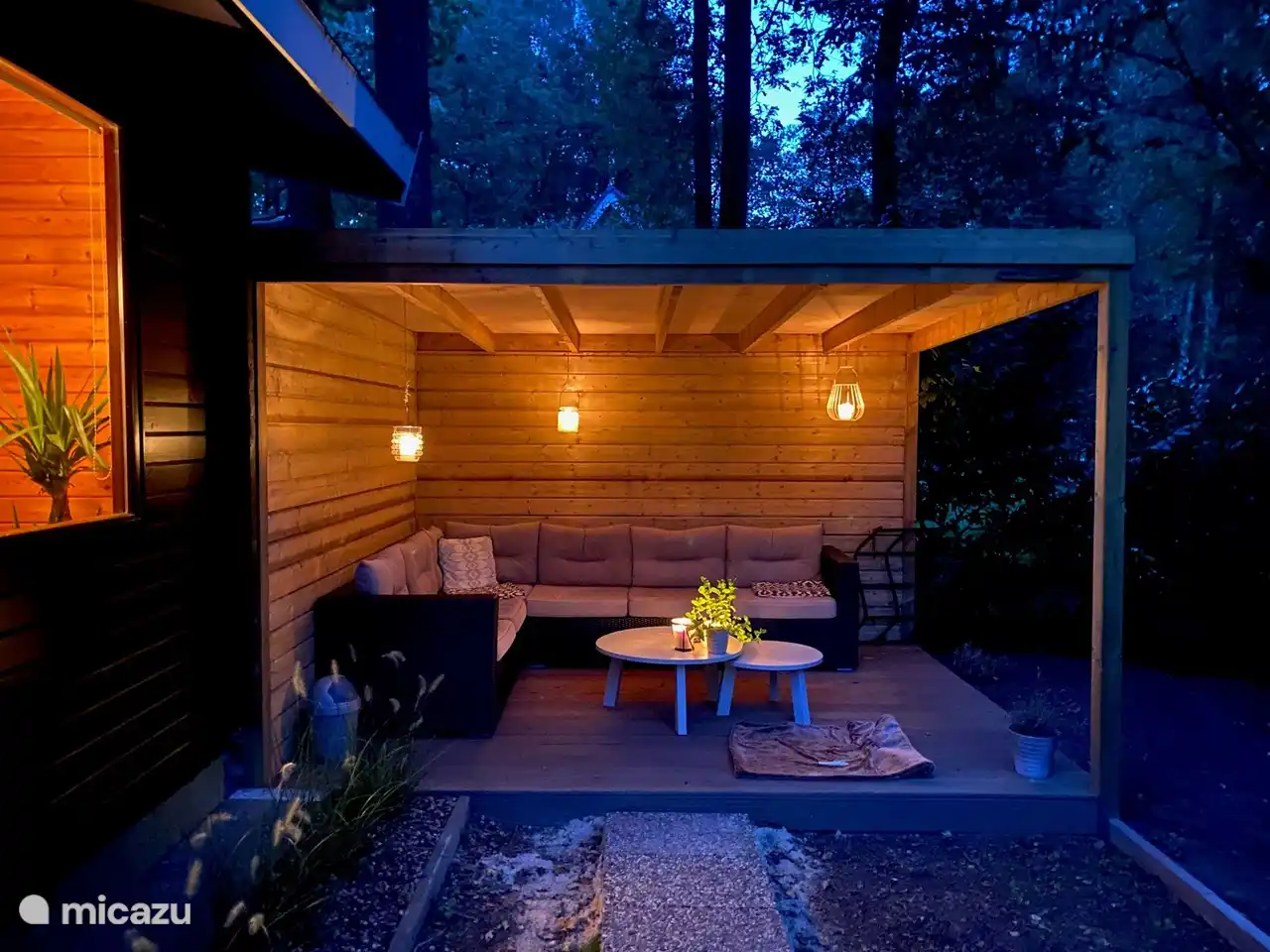 Heerlijke overkapping, bij regen zit je droog en je loopt zo het bos is. Foto bij avond.