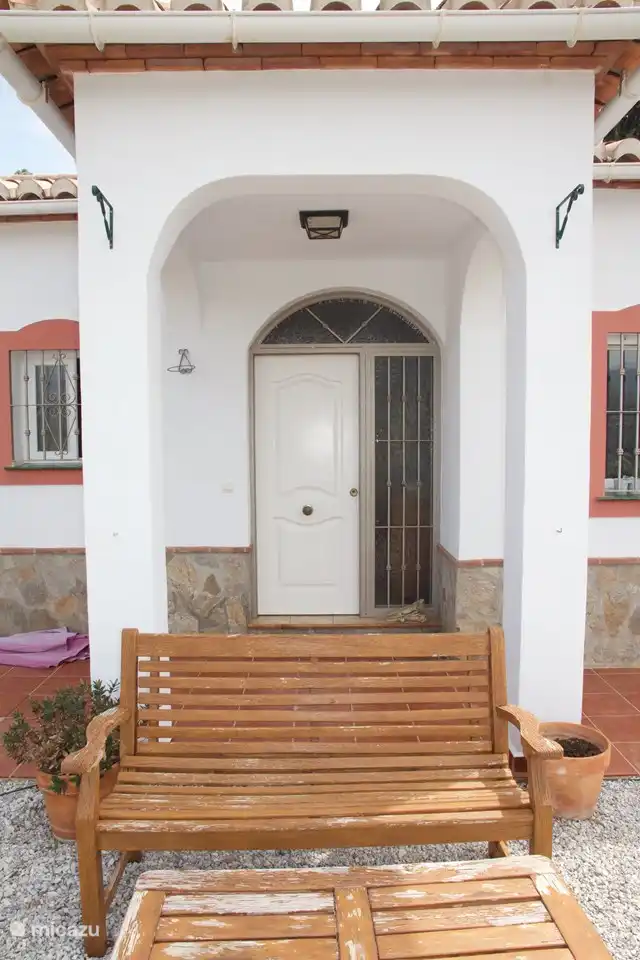 The front door with a bench in front of it