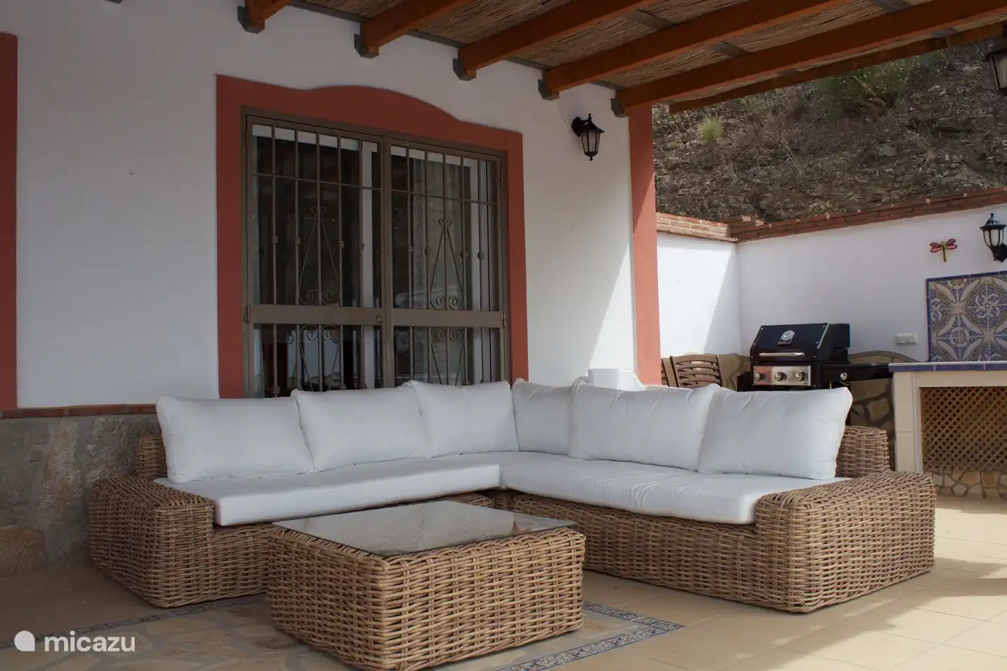 On the terrace a lovely lounge sofa and a gas BBQ