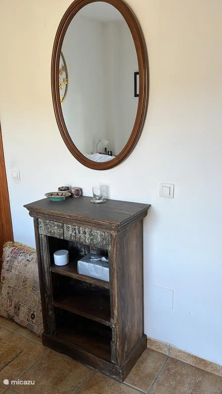 There is now a small bookcase under the mirror