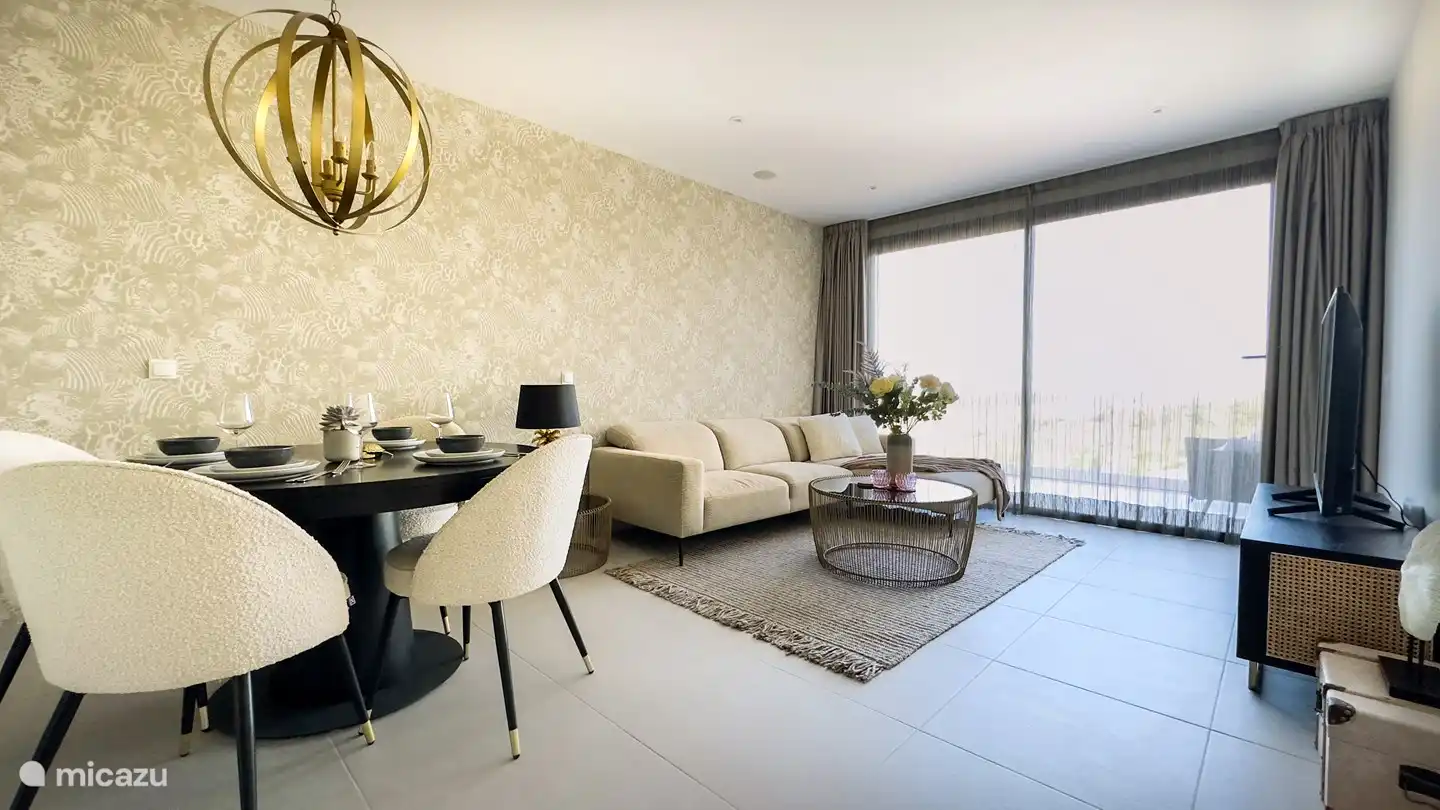 Geräumiges Wohnzimmer mit Zugang zu einer großen Terrasse.