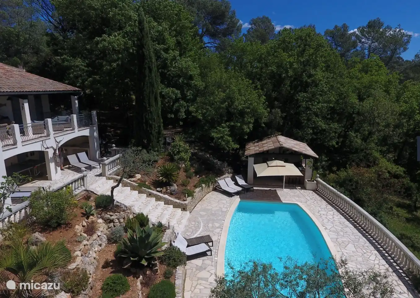 pool house with a lovely lounge set, barbecue and refrigerator