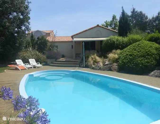 Blick vom Pool auf die Villa. Die Markise verfügt über LED-Beleuchtung und es gibt eine elektrische und sichere Infrarot-Terrassenheizung. Ach ja, auf der Terrasse steht auch ein Weber-Gasgrill.