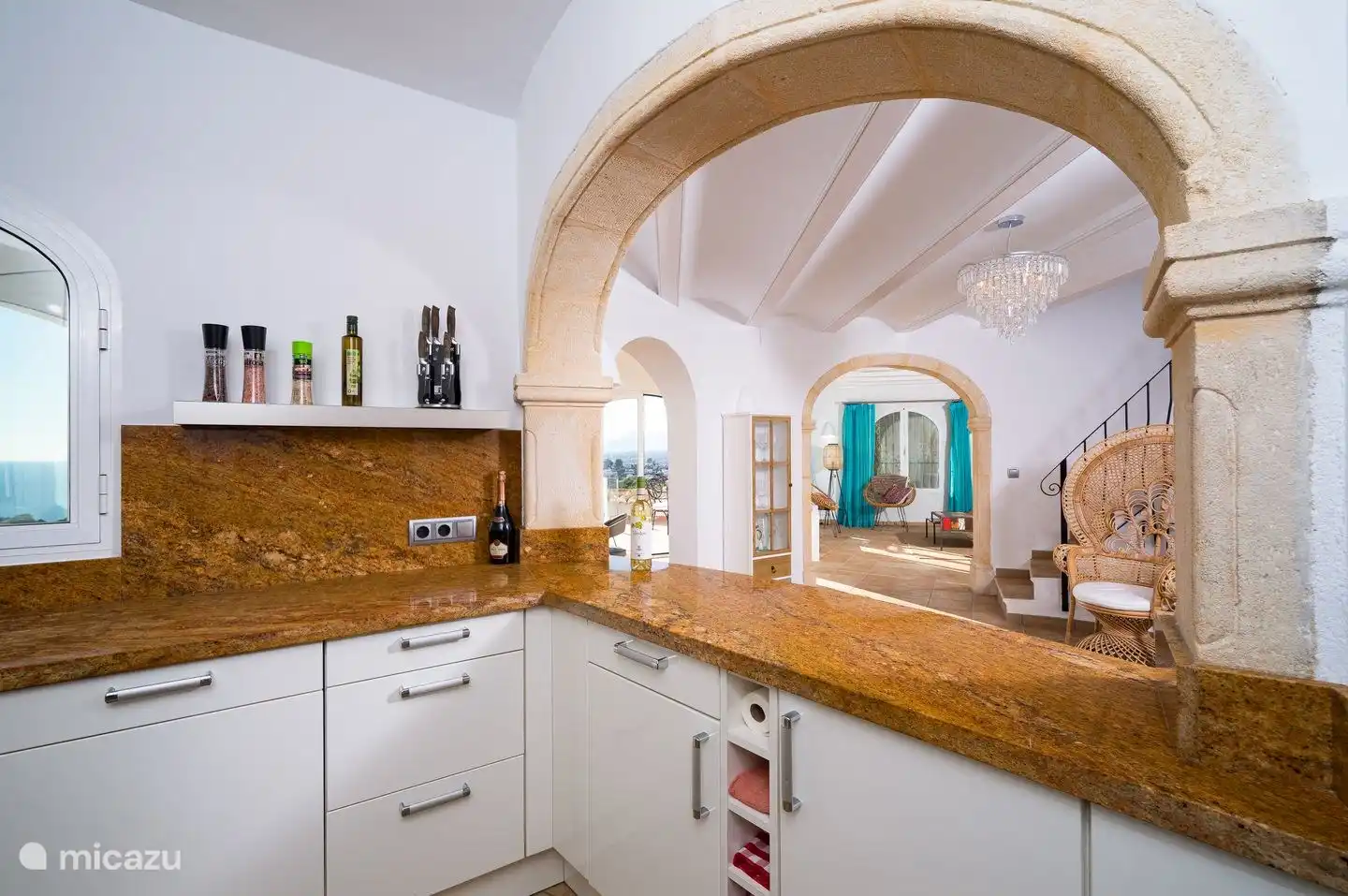 The kitchen of Villa Bahia del Portet is complete and has a nice view through to the living room