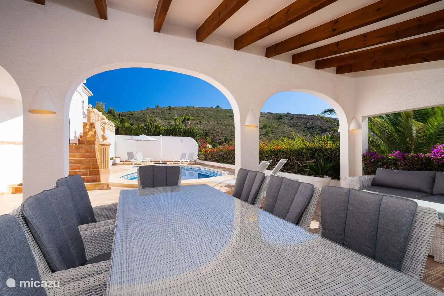 The covered terrace of Villa Bahia del Portet overlooking the private swimming pool