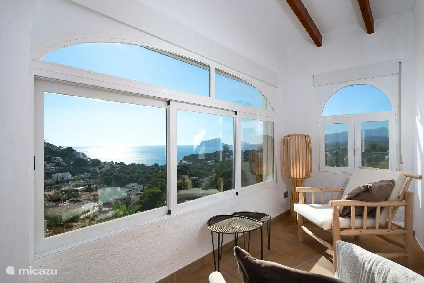 The master bedroom of Villa Bahia del Portet has beautiful sea views