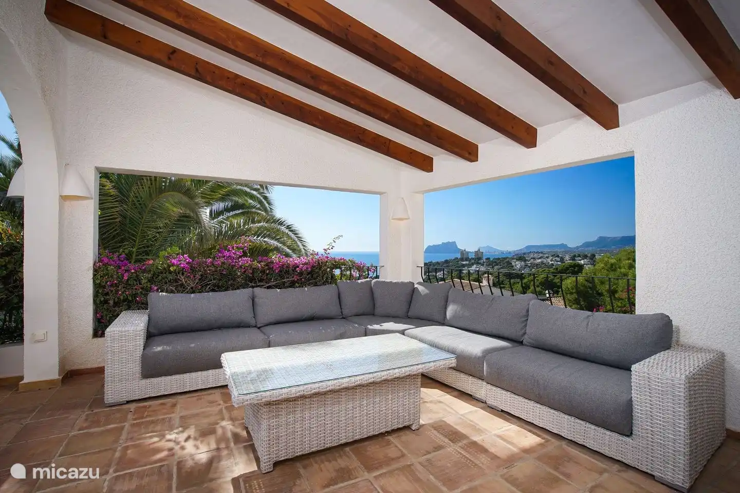 The covered lounge area of Villa Bahia del Portet has a beautiful sea view