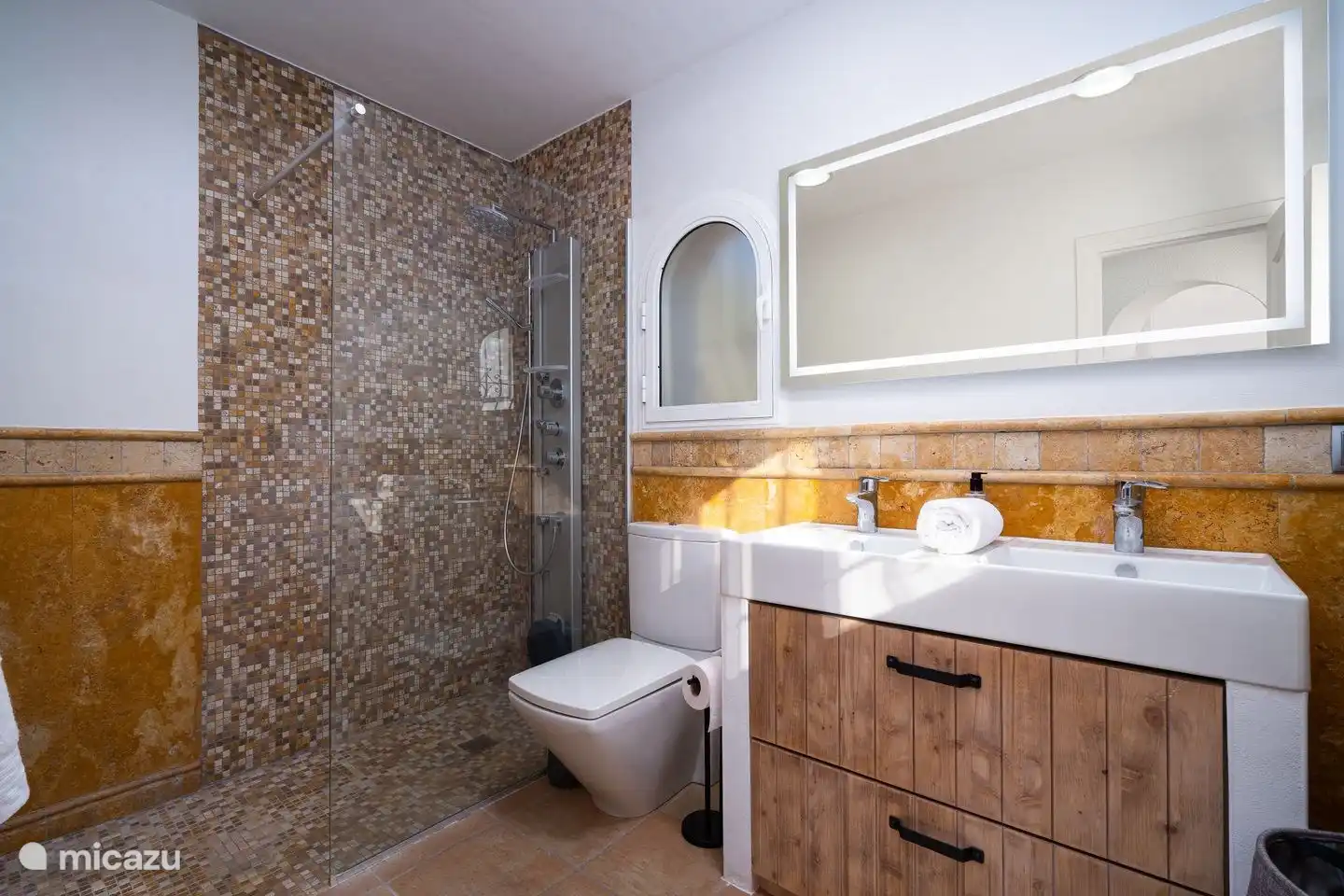 Villa Bahia del Portet has 3 bathrooms with a walk-in rain shower, toilet and sink
