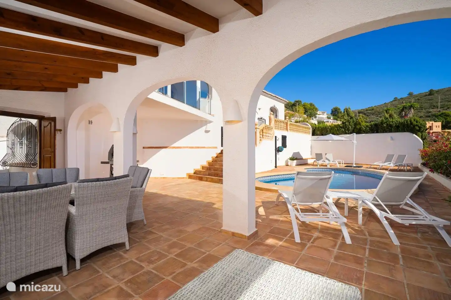 The outdoor kitchen of Villa Bahia del Portet is connected to a private swimming pool