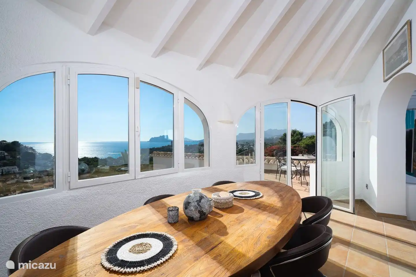 The dining room of Villa Bahia del Portet has panoramic sea views