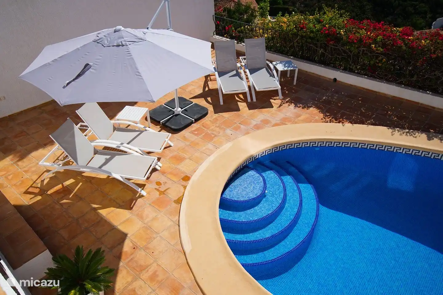 The terrace around the private pool of Villa Bahia del Portet has several sunbeds