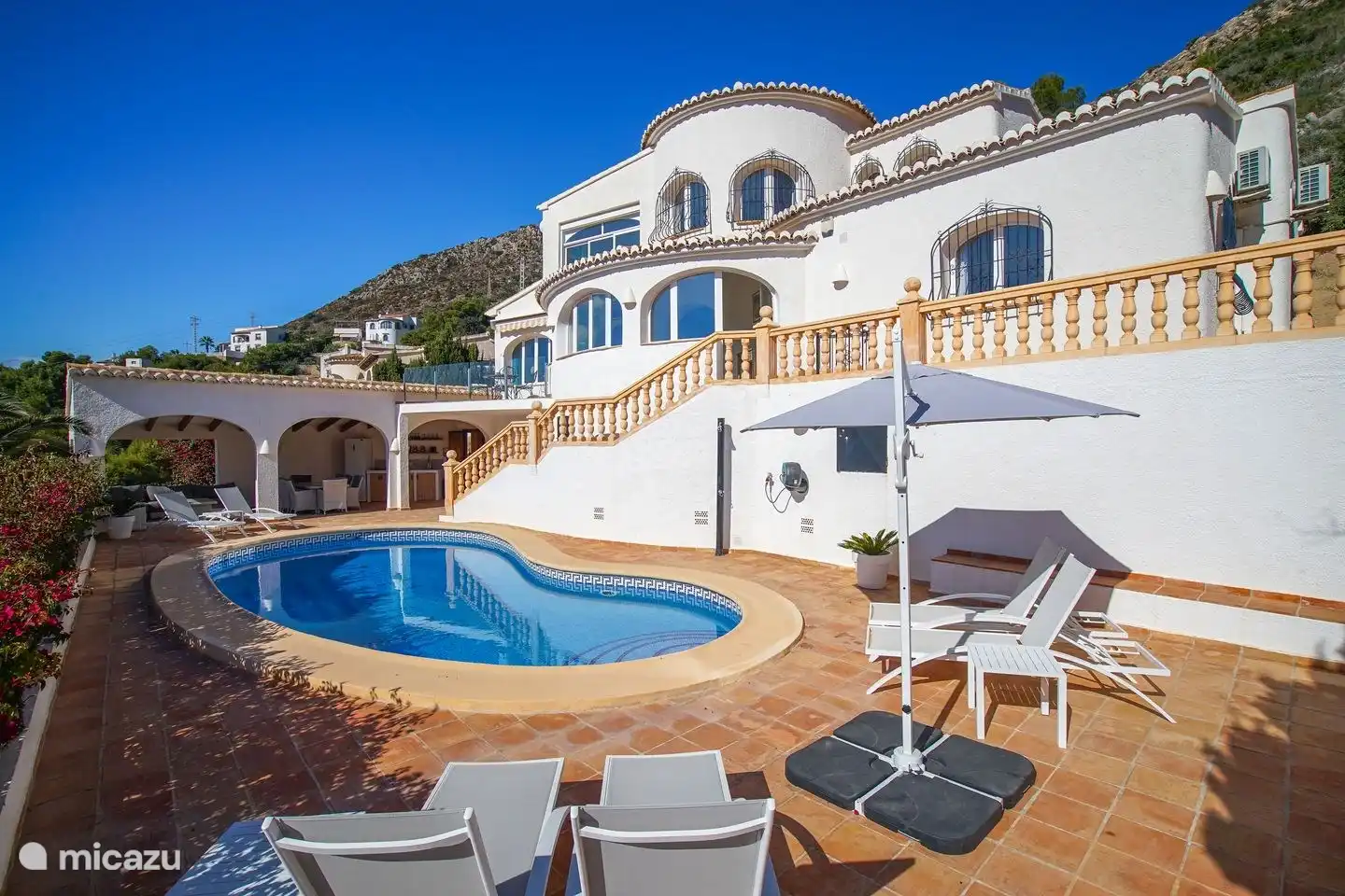 The terrace around the private pool of Villa Bahia del Portet has several sunbeds