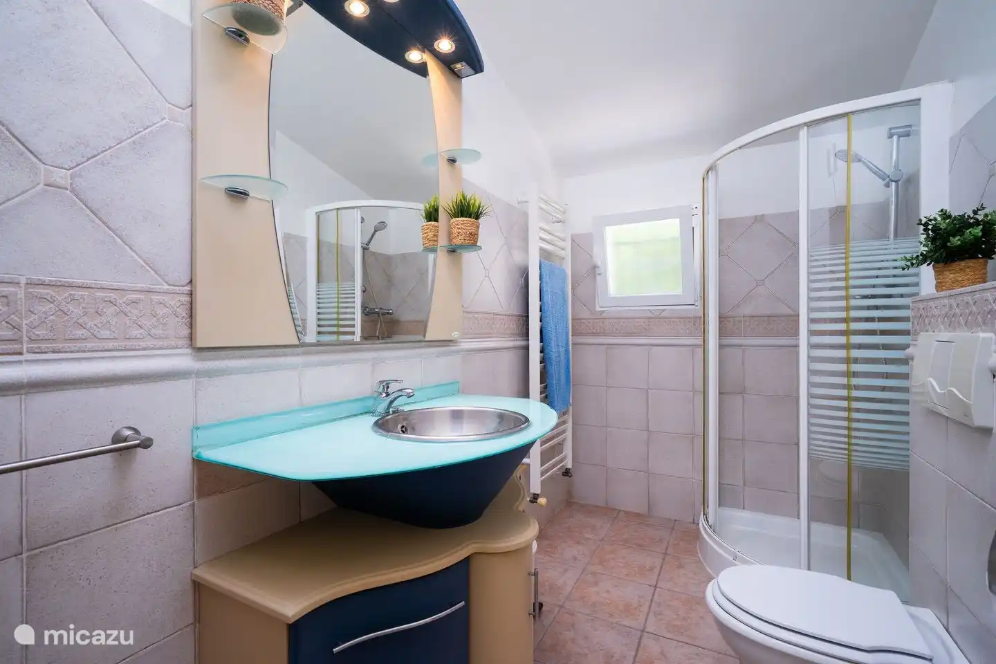 The bathroom of the second bedroom is in the hallway and has a shower, toilet and sink