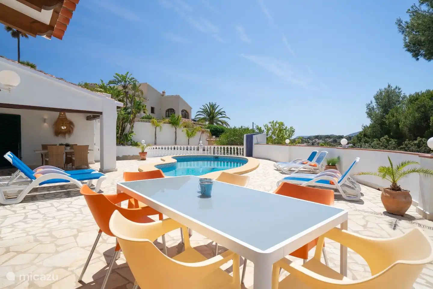 The terrace around the private pool is equipped with sunbeds and seating areas