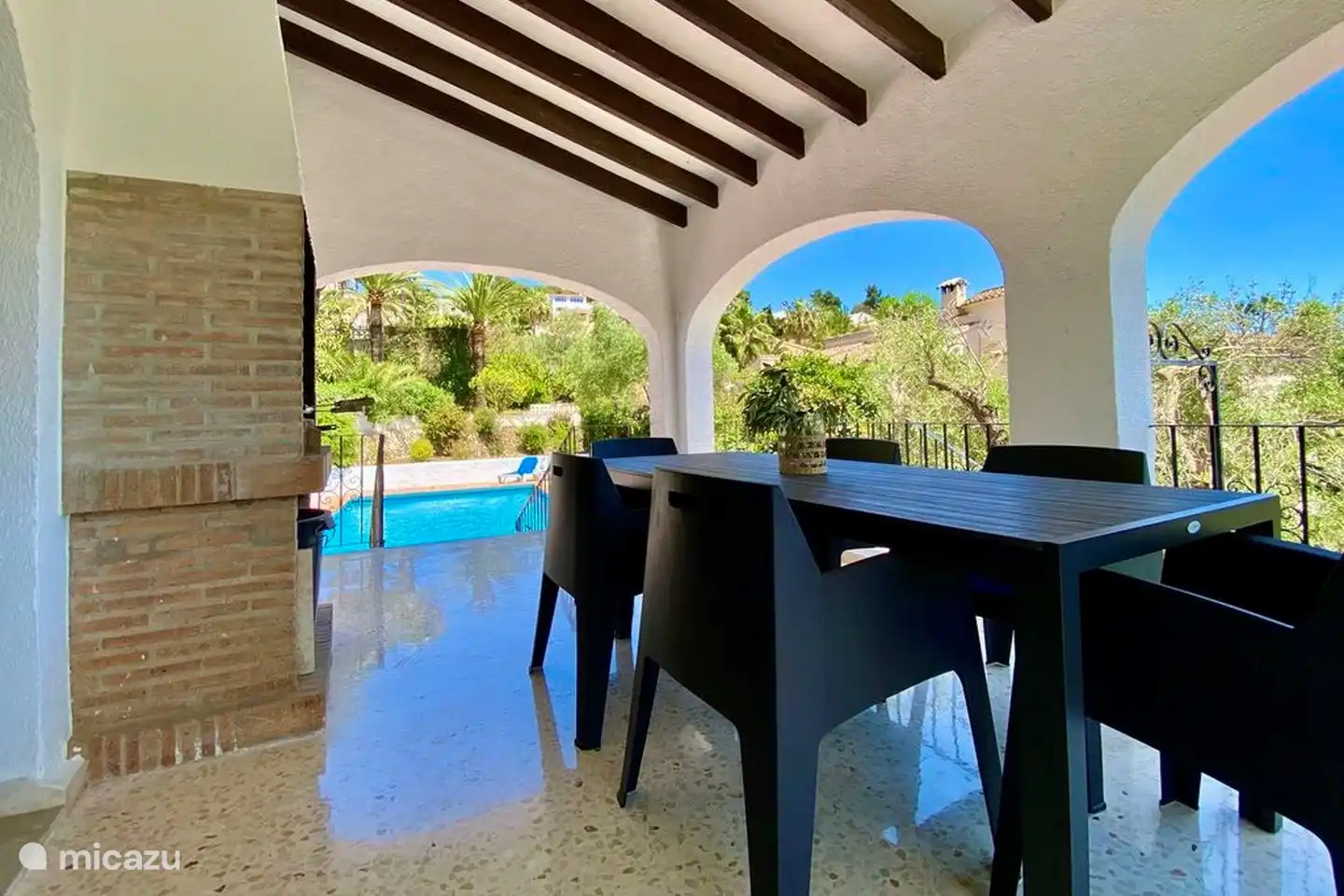 The covered terrace of Villa Olivera has a fixed barbecue
