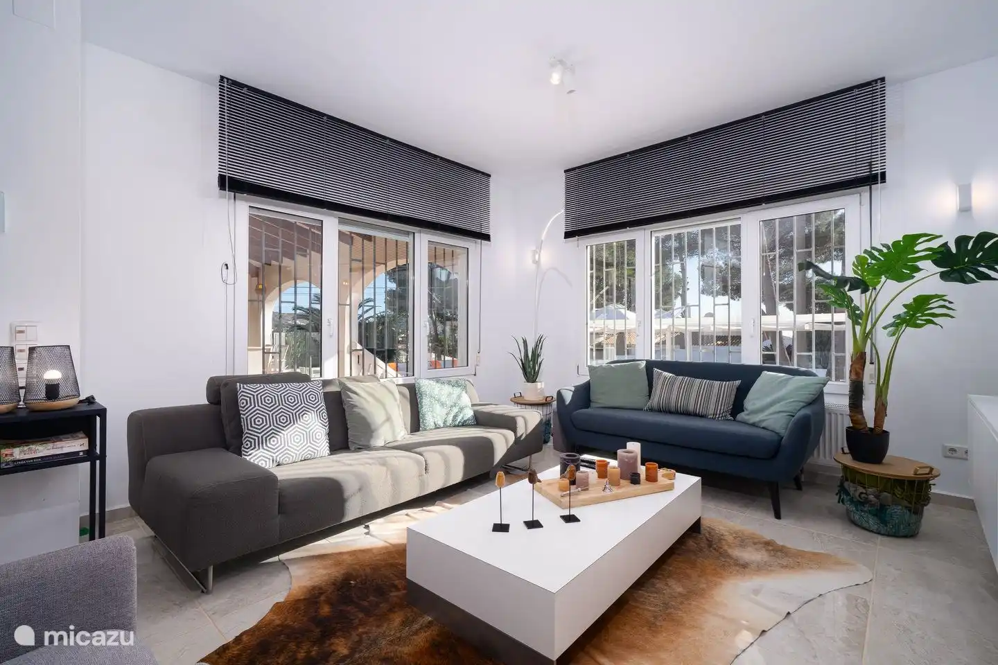 The cozy living room overlooks the garden with private pool