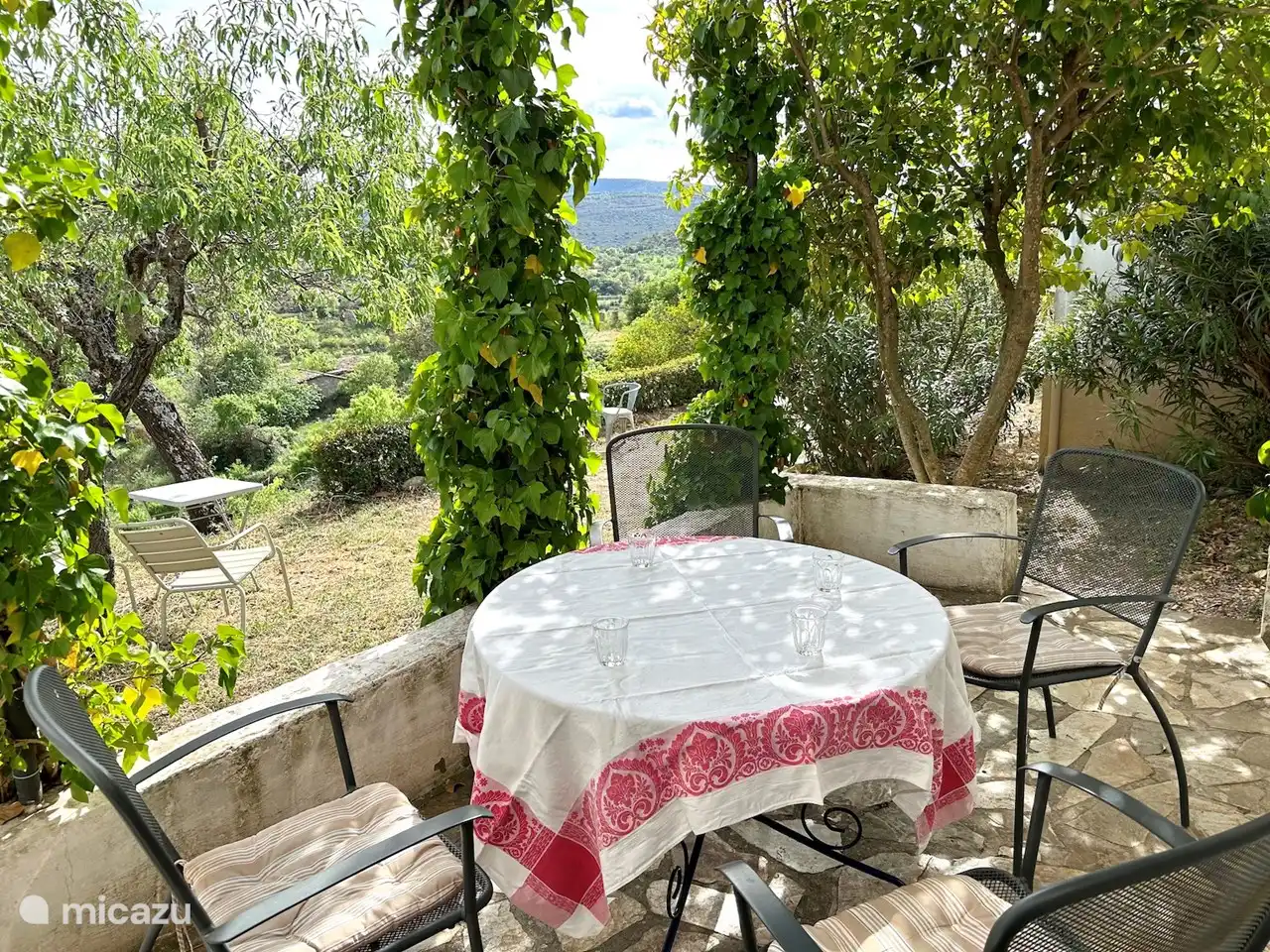table with chairs on shaded terrace with beautiful view