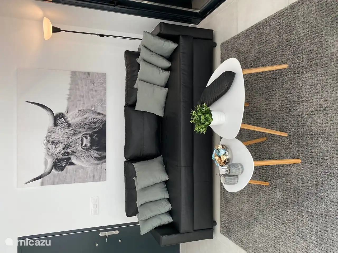 Schönes, geräumiges Sofa in einem gemütlichen Zimmer mit Blick auf den (beleuchteten) Pool, für ein Innen-/Außengefühl.