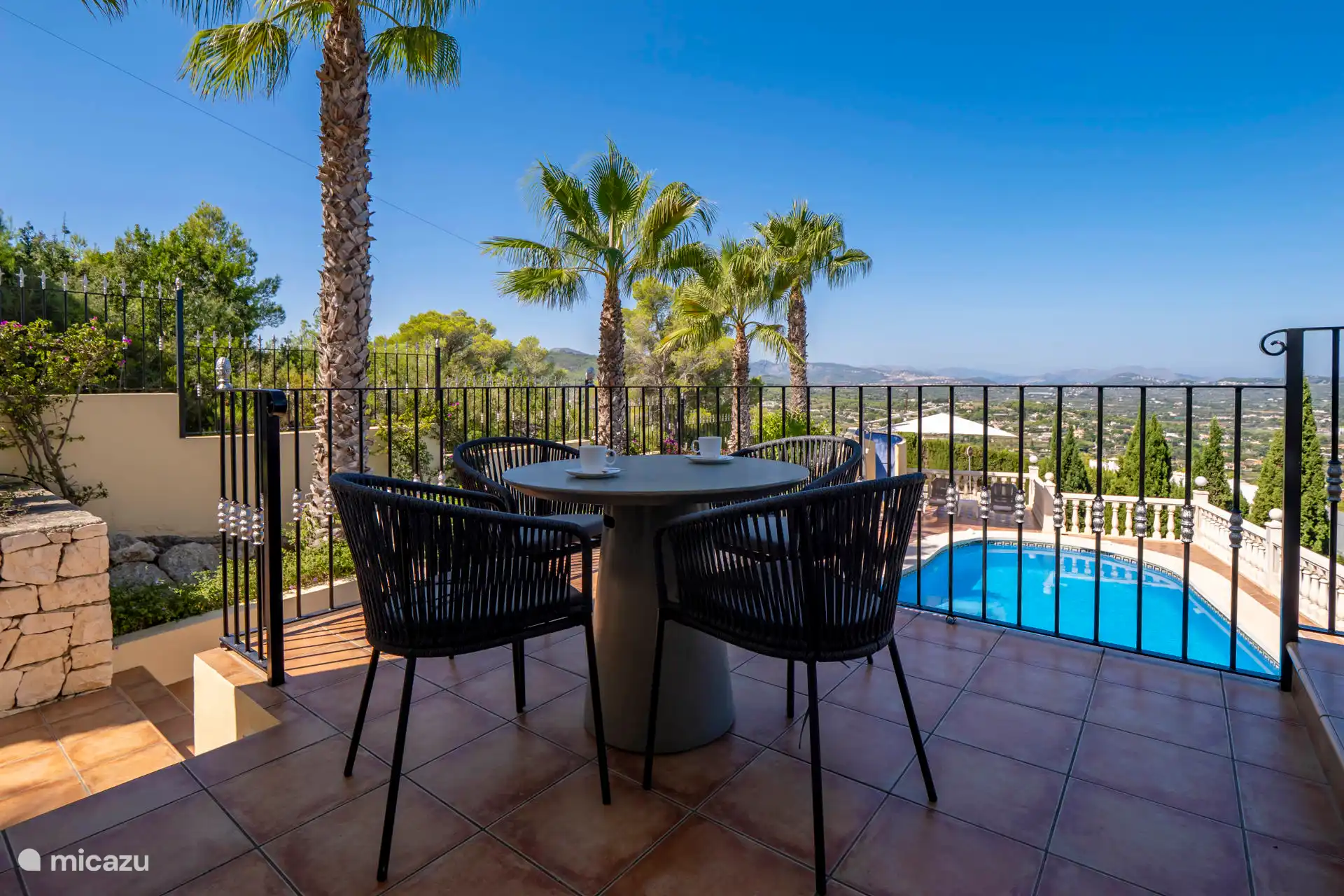 This cozy terrace is directly accessible from the kitchen. Lovely with this view.