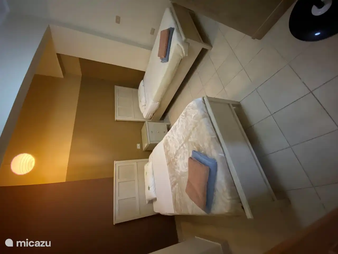 Bedroom with 2 single beds.
This room has no window and no air conditioning but a fan.